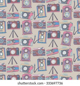Seamless pattern of doodle drawn cameras. Vector background 