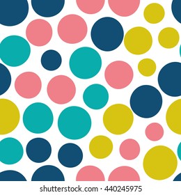 Seamless pattern with dots of fresh colors on a white background. Vector repeating texture.