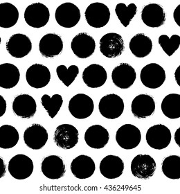 Seamless pattern with dots and hearts. Hand painted black and white ink abstract circles texture. Monochrome paint brush smears background.