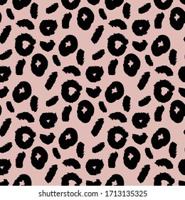 Seamless pattern with dots on pink background. Animalistic style. Vector illustration.