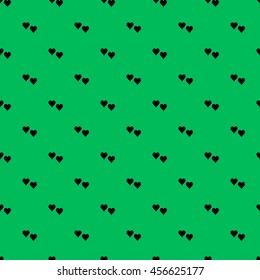 Seamless pattern with double black hearts in diagonal on green background