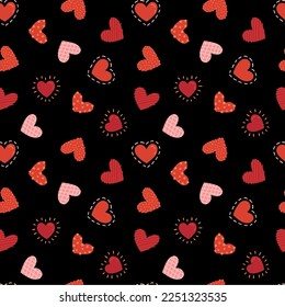 Seamless pattern with drawing se different hearts in red and pink tones on a black background, Valentine's drawing