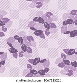 Seamless pattern. Easily editable. Groups of leaves on the background of a checkered pattern with diagonal striation.