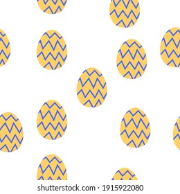 Seamless pattern with easter eggs. Yellow with blue zigzag ornament. White background. Spring religious holiday decoration. Doodle cartoon style. Post cards, textile, wallpaper and wrapping paper