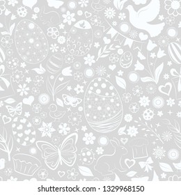 Seamless pattern of eggs, flowers, cakes, hare, hen, chicken and other Easter symbols, white on gray