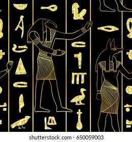 Seamless pattern with egyptian gods and ancient egyptian hieroglyphs with golden glitter foil texture on black background. Vintage hand drawn vector illustration