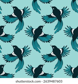 Seamless pattern of elegant black and teal magpies in flight on a soft blue background. 