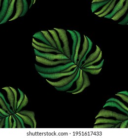 Seamless pattern of embroidered green tropical monstera palm leaves on black background. Embroidery stitches imitation