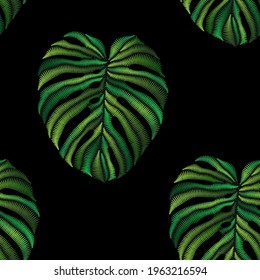 Seamless pattern of embroidered green tropical monstera palm leaves on black background. Embroidery stitches imitation