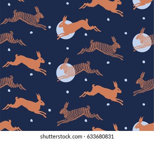 A seamless pattern with embroidered rabbits on blue background. Cute children's ornament. Kid's pattern. Background for textile or book covers, manufacturing, wallpapers, print, gift wrap.