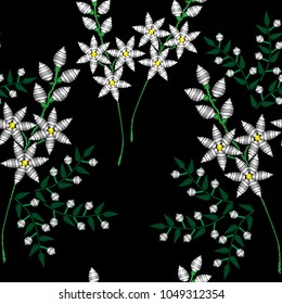 Seamless pattern with embroidery stitches imitation fashion pattern with folk flower. Floral embroidery on black background. Embroidery flower.