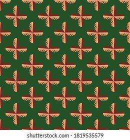 Seamless pattern in ethnic style on a green background.