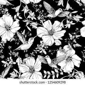 Seamless pattern. Exotic Hibiscus flowers, different herbs and hummingbird. Textile composition, hand drawn style print. Vector black and white illustration.