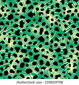 Seamless pattern with exotic palm leaves and black animalistic spots. Vector wallpaper. Tropical boho vibes and animal skin texture.