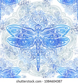 Seamless pattern - exquisite ornate stylized dragonfly against the background of the mandala. Spiritual, esoteric, totem symbol. Ethnic tribal patterns with elements of Ar Nouveau and Boho.