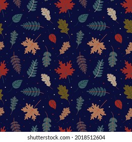 Seamless pattern of fallen leaves and multicolored dots on a blue background