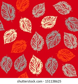 Seamless pattern with fallen leaves on red background