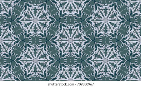 Seamless pattern. Fantastic snowflakes are located like bees' honeycombs. The abstract six-sided figures. For backgrounds, fabrics, holidays. Different of blue-gray tones.