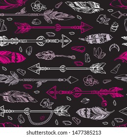 Seamless pattern of feathers, flowers and crystals. Tribal ethnic items isolated on black background. Hand drawn abstract doodle feather texture. Vintage vector illustration for your cover or print.