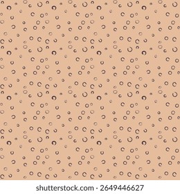A seamless pattern featuring numerous small, dark, imperfect circles and crescent shapes scattered across a light brown or peach background, creating a whimsical, hand-drawn aesthetic.