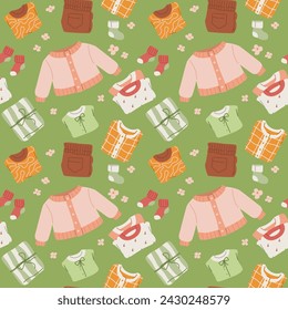 Seamless pattern featuring a variety of child clothing items. Collection of cute kids apparel on green background. Top view. Flat vector illustration.