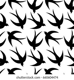 Seamless pattern with a flock of swallows. Vintage background of silhouettes of birds in the sky. Vector illustration.