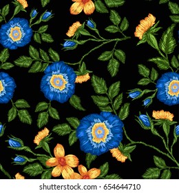 Seamless pattern of floral embroidery on a black background.