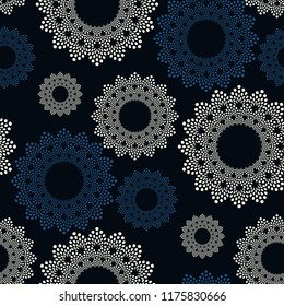 seamless pattern with floral flakes in ivory blue on black