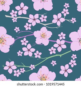 Seamless pattern from flowers and cherry branches on a green background