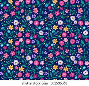 Seamless pattern with flowers for design. Small colorful flowers.Dark blue background. Modern floral background. The elegant the template for fashion prints. Ditsy style.