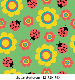 Seamless pattern with flowers and ladybirds on green