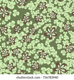 Seamless pattern. Flowers and leaves are scattered chaotically. Fashionable camouflage.