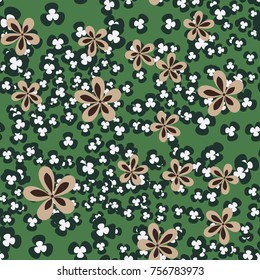 Seamless pattern. Flowers and leaves are scattered chaotically. Fashionable camouflage.