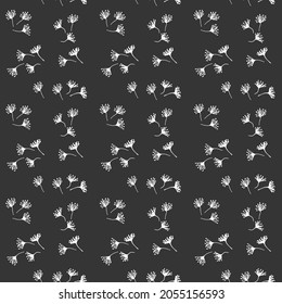 Seamless pattern with flowers and twigs on a dark background.