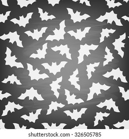 Seamless pattern with flying bats on chalkboard. Halloween background.