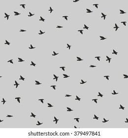 Seamless pattern with flying birds silhouettes