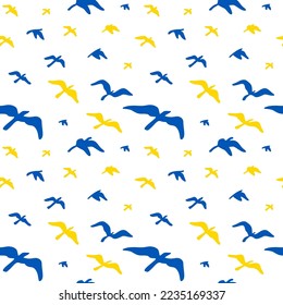 Seamless pattern with flying birds in Ukrainian flag yellow and blue colors. Vector illustration