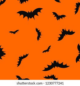 Seamless pattern with flying black bats silhouettes on orange background for Halloween. Vector illustration. Autumn party. Trick or treat. 