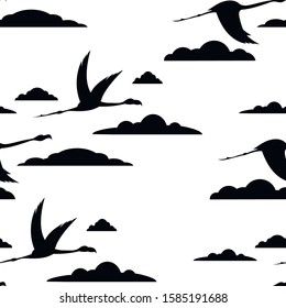 Seamless pattern of flying black silhouettes of birds, flamingos