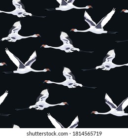 Seamless pattern with flying Japanese cranes bird on black background.