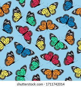 Seamless pattern with flying multicolored butterflies on a blue background. Vector illustration.