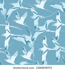 Seamless pattern with flying white-tailed tropicbird. Vector illustration.