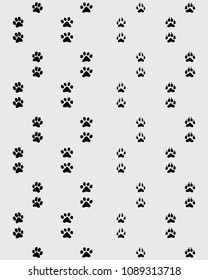 Seamless pattern of footprint of paws on a gray background