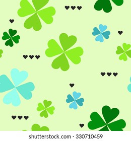 Seamless pattern with four leaf clover leaves with black hearts on the green background