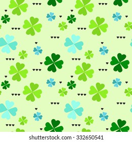 Seamless pattern with four leaf clover leaves with black hearts on the white background