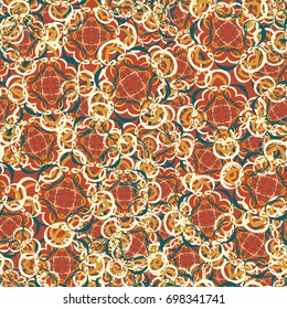 Seamless pattern. Four-sided colored figures. Flower motifs. Random order. Grunge style. Brown, gold tones, blue-green.