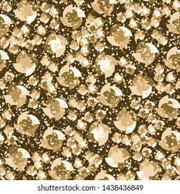 Seamless pattern. Four-sided multi-colored round elements are arranged randomly. The colors of gold. Shades of yellow, brown.