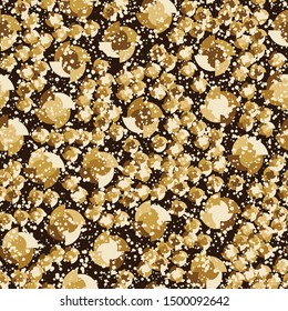 Seamless pattern. Four-sided multi-colored round elements are arranged randomly. The colors of gold. Shades of yellow, brown.