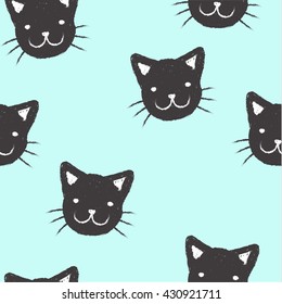 Seamless pattern with freehand painted muzzles kittens on a blue background