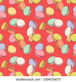 Seamless pattern with french macaroons. Hand drawn vector illustration in vintage engraving style on red background. Sweet colorful dessert.